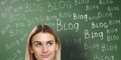6-marketing-and-design-blogs-to-follow_ woman standing in front of chalkboard with blog written
