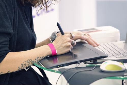 Are you looking to hire a graphic designer or hoping to find a job as one? Here’s what you need to know. graphic designer working on tablet