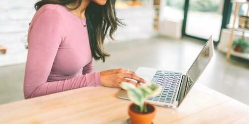 As a contract employee, you may have the autonomy to work remotely. young woman works in public space with laptop