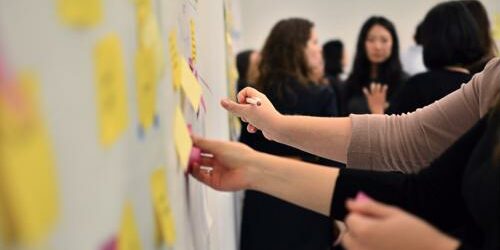 Brand managers work with every aspect of the company to make sure their strategy meets all goals. People planning a brand strategy.