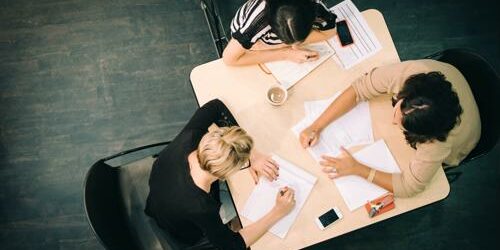 Employees working in a creative work environment. Creative staffing recruitment specialists find candidates that enhance your work environment.