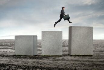 Guy-Jumping-Milestones1 man jumping up large cement blocks in the middle of nowhere