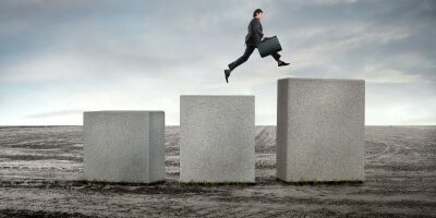 Guy-Jumping-Milestones1 man jumping up large cement blocks in the middle of nowhere