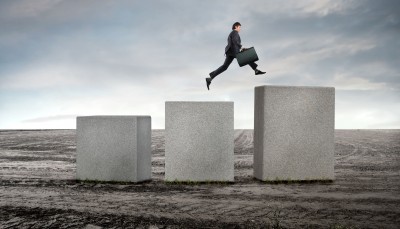 Guy-Jumping-Milestones1 man jumping up large cement blocks in the middle of nowhere