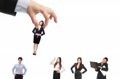Interview-Basic-Tips_Plucked-from-a-line 5 people standing in a like one being picked up by a large hand