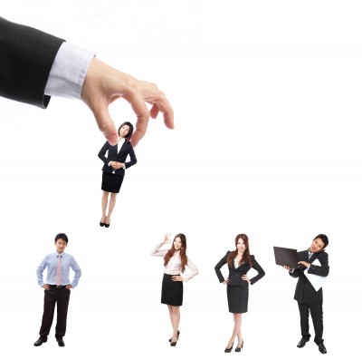 Interview-Basic-Tips_Plucked-from-a-line 5 people standing in a like one being picked up by a large hand