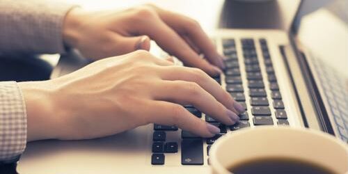Technical writers need to be able to communicate complicated technology to all types of audiences. Woman typing on a laptop.