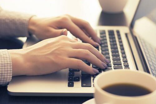 Technical writers need to be able to communicate complicated technology to all types of audiences. Woman typing on a laptop.