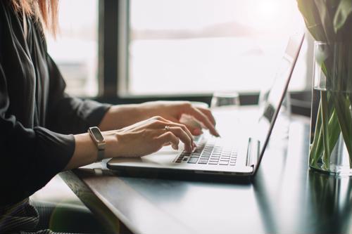 Web content managers create and oversee all copy that appears on a company’s website. web content manager typing on laptop