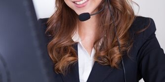 Benefits of Outbound Marketing Woman working in a call center smiling a the camera