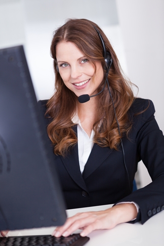 Benefits of Outbound Marketing Woman working in a call center smiling a the camera