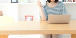 blogging woman working at her desk in a bright office