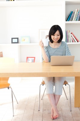 blogging woman working at her desk in a bright office