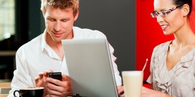 byod two people working on their electronics in a coffee shop