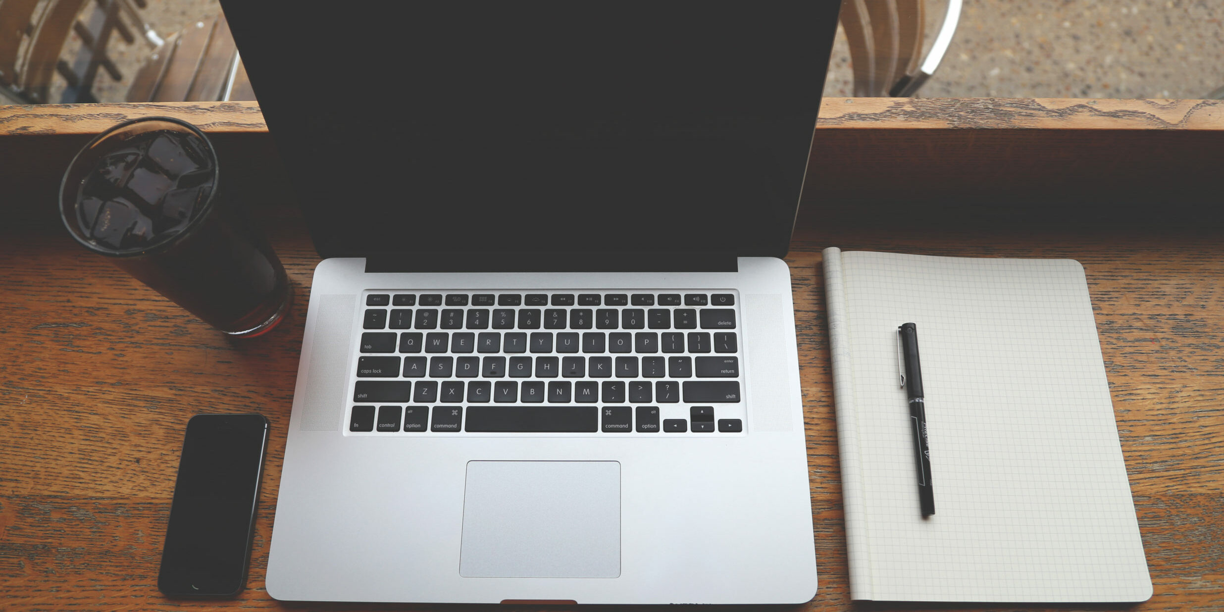 Remote Workers coffee iphone and laptop on wooden desk