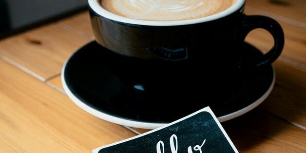 company culture and remote onboarding cappuccino in black mug with hello name tag remote onboarding