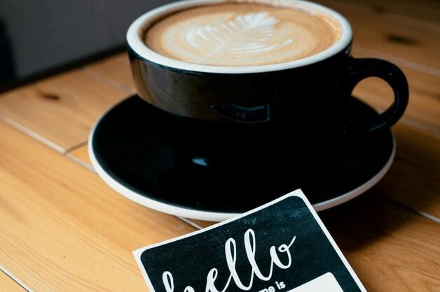 company culture and remote onboarding cappuccino in black mug with hello name tag remote onboarding