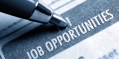 Conduct a discreet job search while you are employed pen pointing to job opportunities in a paper