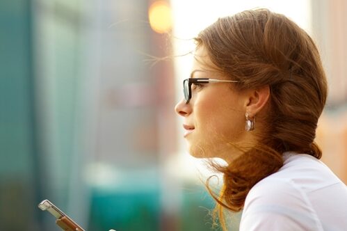 Creative staffing solutions: Benefits of hiring contract workers Woman on her phone looking out into the distance