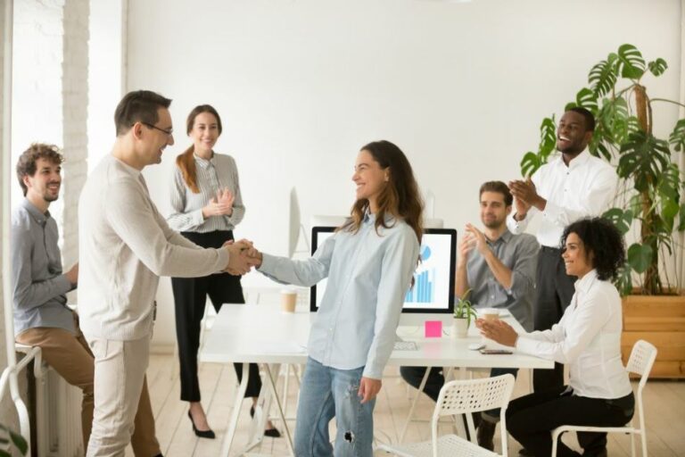 direct hire staffing stays strong in 2020 woman employee shakes hands with male colleague