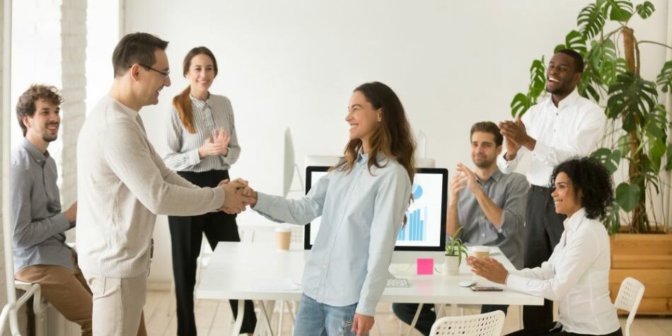 direct hire staffing stays strong in 2020 woman employee shakes hands with male colleague