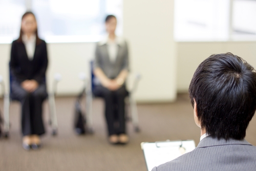Don't be white noise when applying to jobs two women sitting to wait for an interview with the boss calling their name