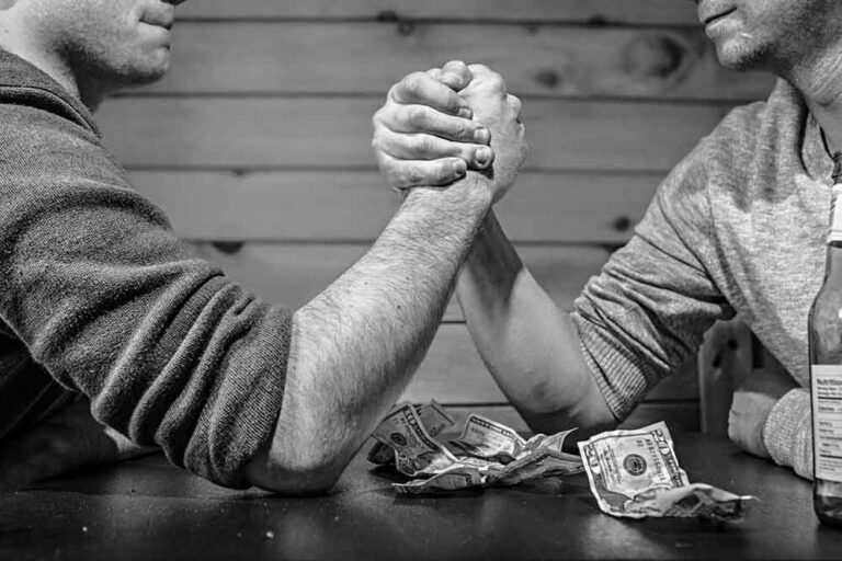 dont say these things to your web designer two people arm wrestling for money at a bar