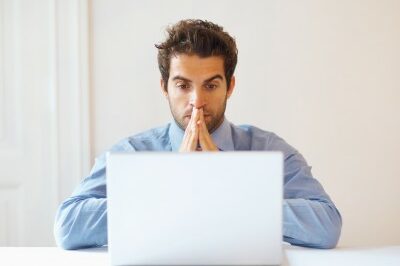 emergency man looking at his computer hopeful