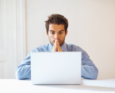 emergency man looking at his computer hopeful
