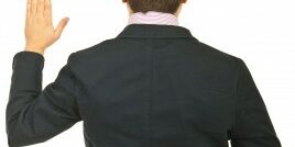 fingerscrossed man with his fingers crossed behind his back as he makes a promise