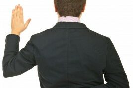 fingerscrossed man with his fingers crossed behind his back as he makes a promise