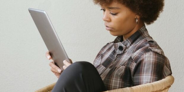 furlough defined employee rights_2 woman on furlough on tablet