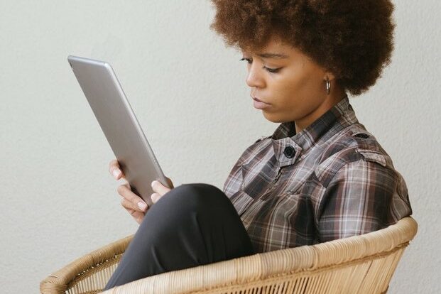 furlough defined employee rights_2 woman on furlough on tablet
