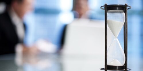 Here's how to get started on those days that you just can't seem to focus. two people looking at paperwork with a sand timer in the foreground