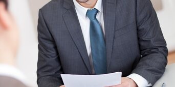 Hire the right candidates the first time around man smiling in an interview