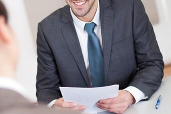 Hire the right candidates the first time around man smiling in an interview