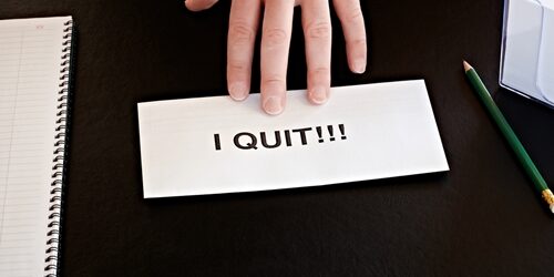 How To Bounce Back When Top Talent Leave person pushing a piece of paper saying "I quit" on it