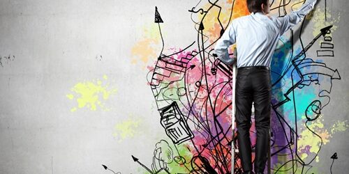 How to Improve the Creative Process business man creating graffiti on the wall