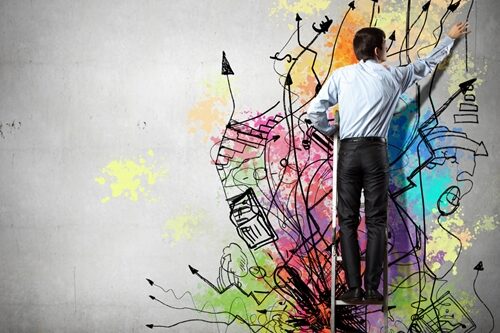 How to Improve the Creative Process business man creating graffiti on the wall
