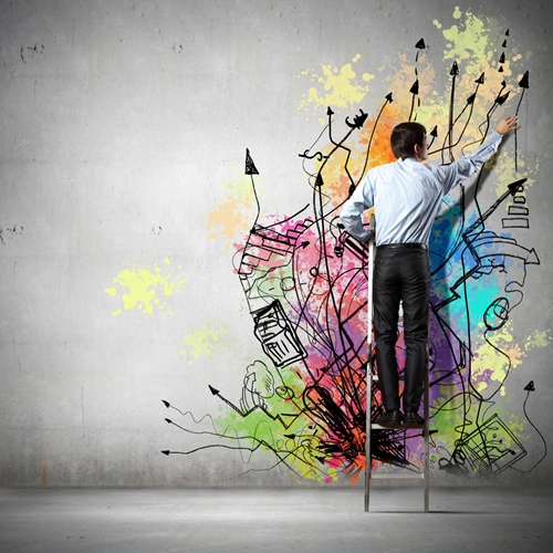 business man creating graffiti on the wall