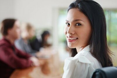 manager woman in a meeting smiling at the camera