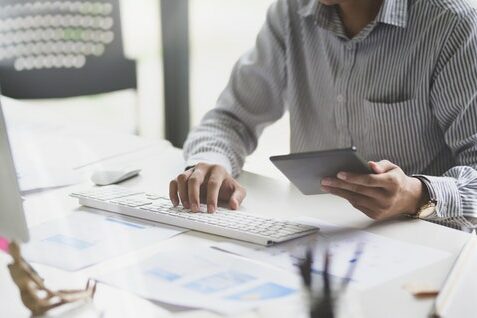 person at computer with tablet second wave of coronavirus person at computer with tablet second wave of coronavirus