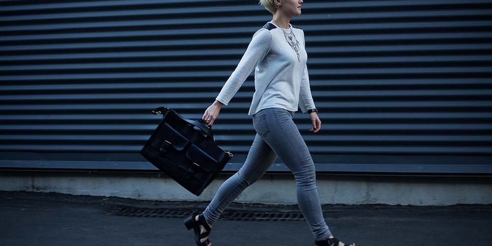 quitting-your-job-gracefully Woman walking down an alley with a brief case