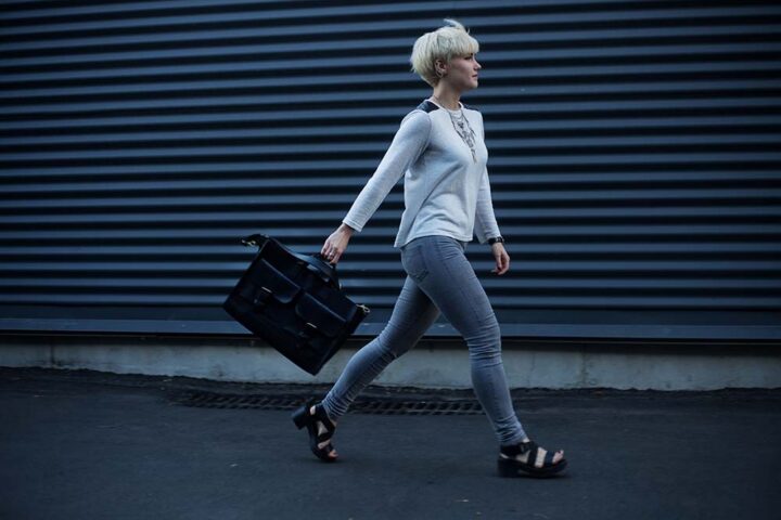quitting-your-job-gracefully Woman walking down an alley with a brief case