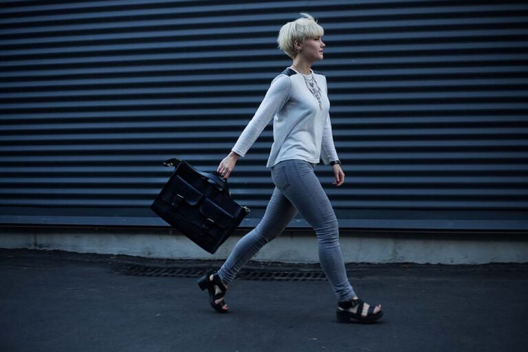 quitting-your-job-gracefully Woman walking down an alley with a brief case