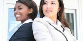 references2 two women back to back with their arms crossed posing