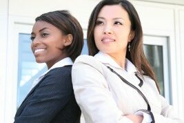 references2 two women back to back with their arms crossed posing