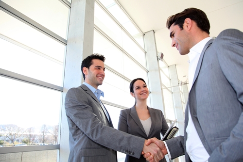 Run the show and become an in-demand contractor two men shaking hands with woman smiling next to one of them