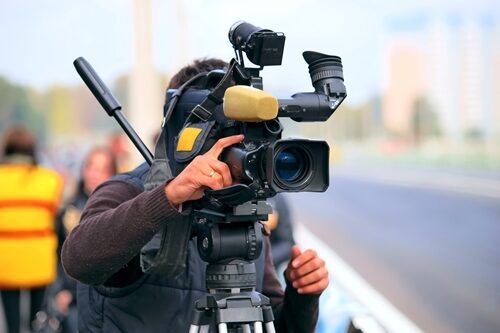 The high ROI of video content marketing Camera man working