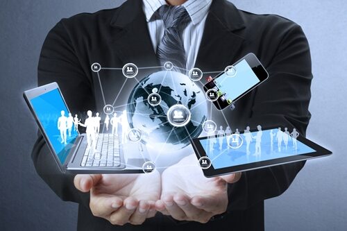The importance of a UX strategy man holding his hands out with a laptop and tablet floating above them